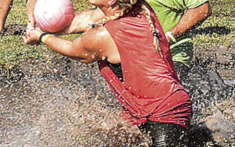 IT GETS MESSY for these mud volleyball players at the Hog Splash last Saturday in Snook.