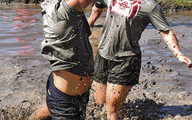 THE BALL GOES awry for these mud volleyball players on Saturday at the Hog Splash in Snook.