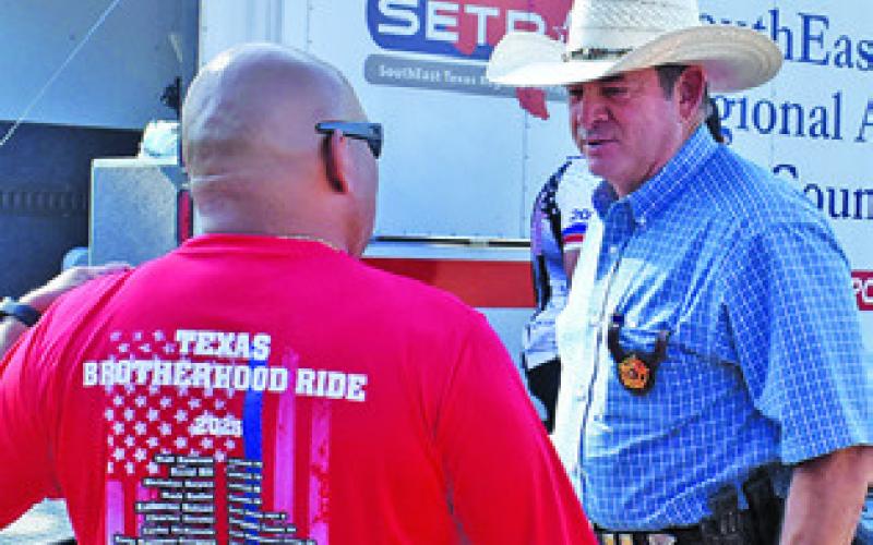 BURLESON COUNTY Sheriff Bill Rios greets a member of the Texas Brotherhood Ride on Thursday, Sept. 11, in Caldwell.