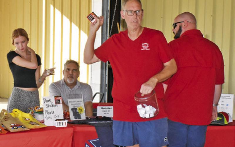 JOHN SMITH ADDRESSES the crowd on Saturday at the Deanville Volunteer Fire Department’s Community Night Out.