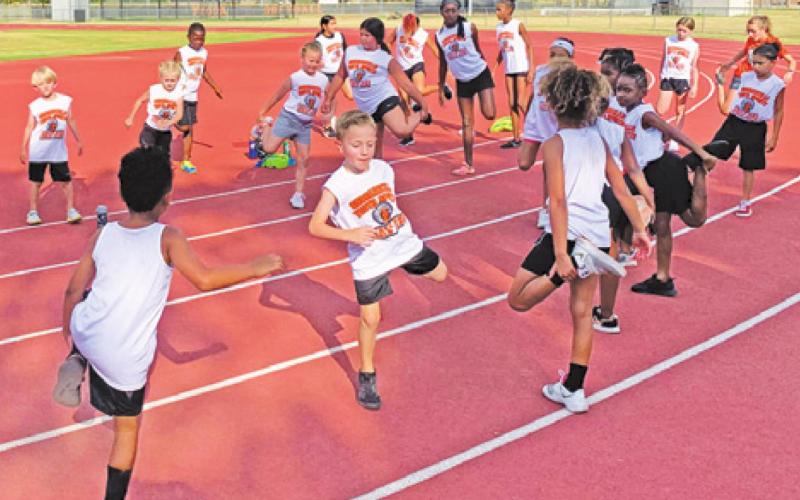 MEMBERS OF THE SOMERVILLE Youth Sports track team warm up before the track meet held in Somerville last Thursday, July 14.