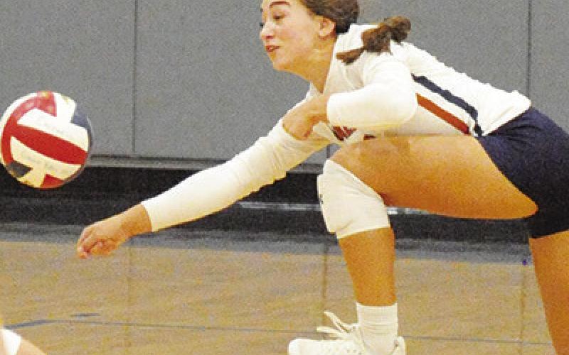 NATALIE EASTEPP reaches towards the ball to attempt to save it from hitting the floor during the Caldwell-Giddings match on Friday.