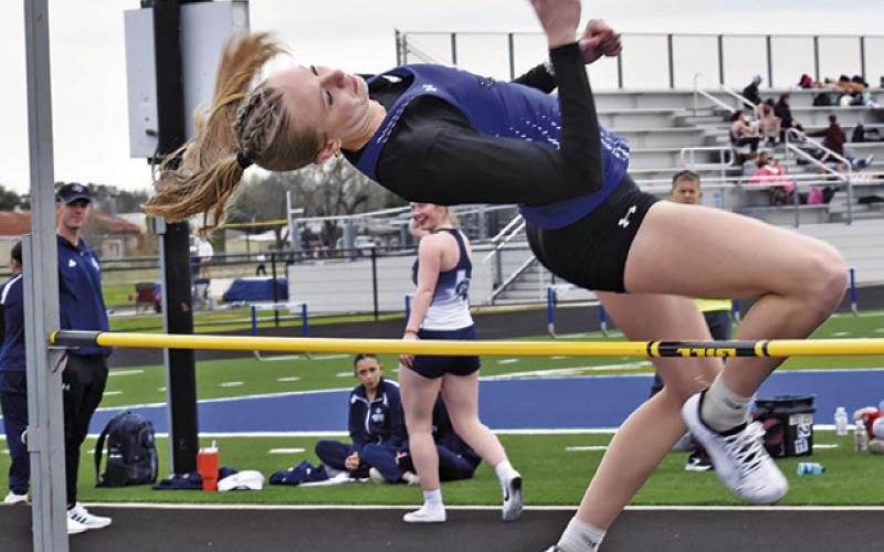 DAKOTA KIENOW LEAPS in the varsity girls high jump at last week’s Bluejay Relays. Tribune photo by Roy Sanders