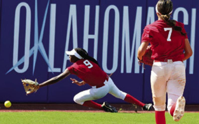 MESHA JOHNSON REACHES for a ball at the fence while playing centerfield during the USA Softball All-American Games in Oklahoma.