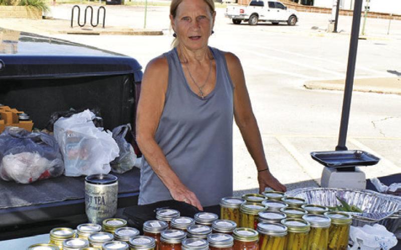 VICKIE DASH DISPLAYS her canned goods for sale on Saturday at the Farmers Market.
