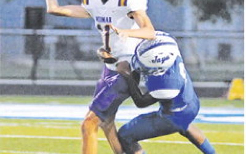 SNOOK’S MARK Moore makes a tackle last Friday night against Weimar in Snook. -- Tribune photo by Denise Squier