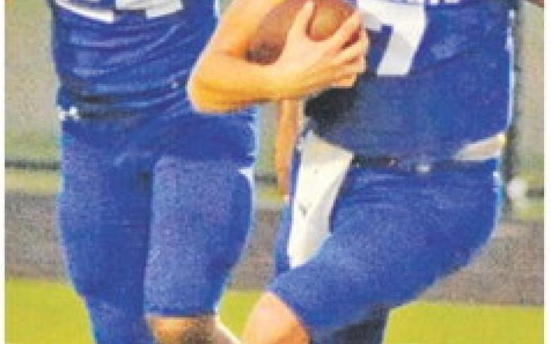 J. BEAUX Hruska carries the ball for Snook as Mark Moore gets ready to block.