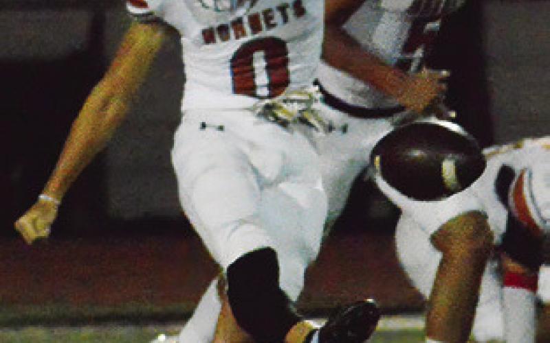CALEB RACKEL of Caldwell kicks during the Hornets’ 49-34 win at Smithville. Tribune photo by Sabine Lazo