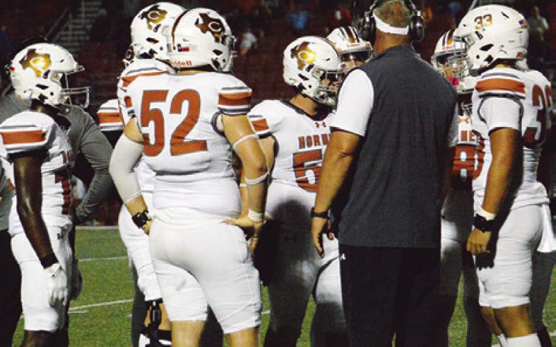 CALDWELL HIGH SCHOOL Head Coach Sean Witherwax talks to his team during a timeout on Friday at Smithville. Tribune photo by Sabine Lazo