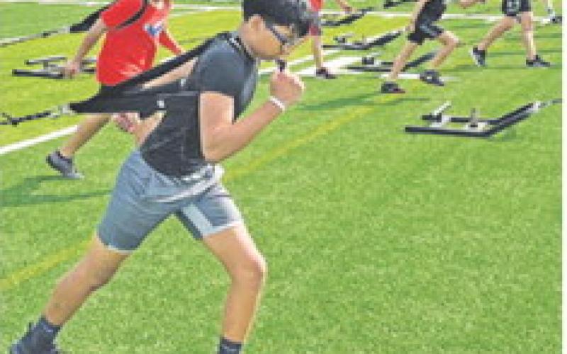 THESE STUDENTS PULL WEIGHTS during this summer’s Caldwell ISD athletics Strength and Conditioning Camp at the high school.