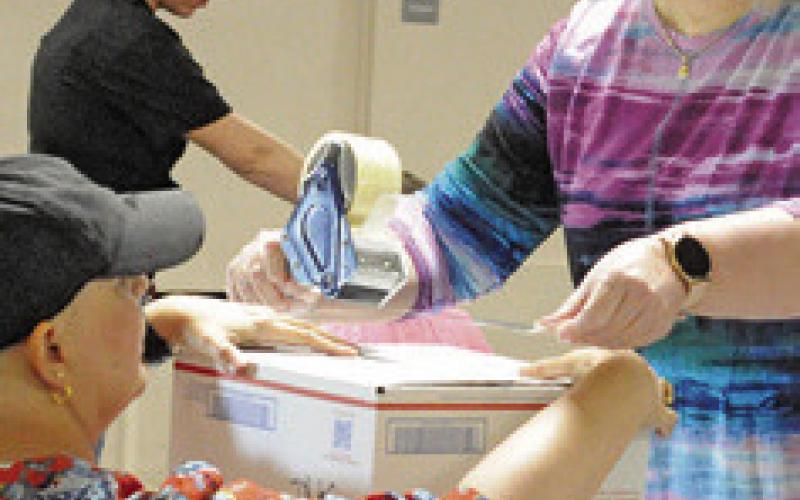 AREA RESIDENTS prepared boxes for shipping to breast cancer surgery patients during Saturday’s Blessing Box Project “Sew-In,” hosted by the Snook EEA.