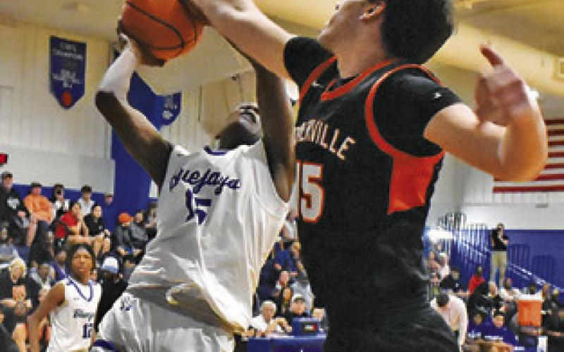 BUD MOORE of Snook shoots as Irman Sadic of Somerville blocks the shot.