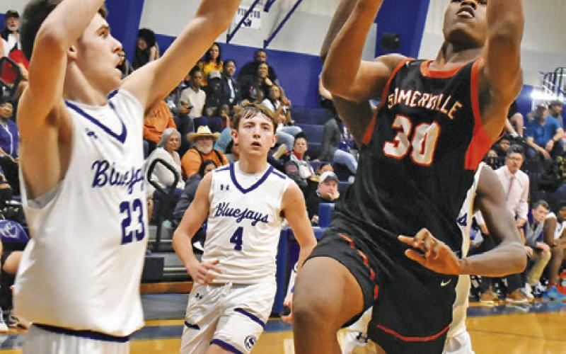 SOMERVILLE’S KEKE DANIELS taks a shot as Snook’s Josh Green defends. Somerville won 78-36. -- Tribune photo by Roy Sanders