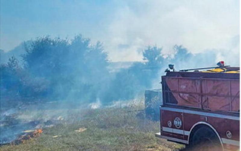 SOMERVILLE AND SNOOK volunteer firefighters battle this blaze off F.M. 1361. Photo courtesy of Snook Volunteer Fire Department