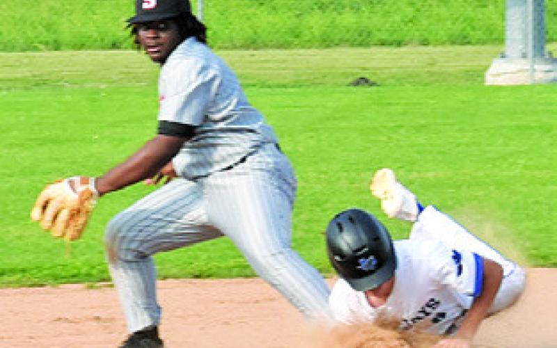 RAIJOIN SHIVERS of Somerville gets ready to throw the ball as Snook’s Brett Withem slides into base. Snook won the game 8-7. Tribune photo by Roy Sanders