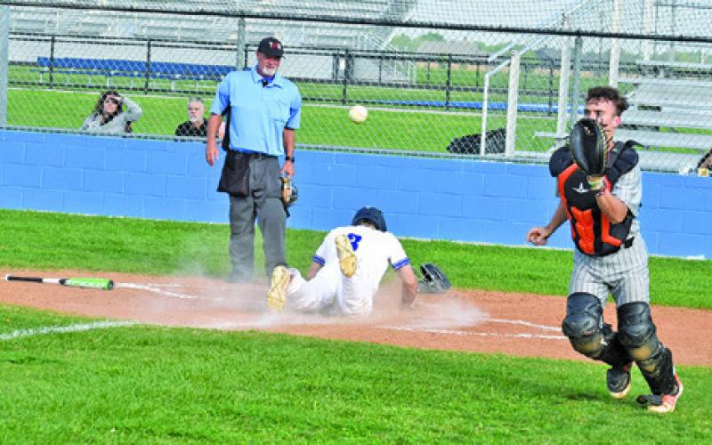 COLT HOLTON OF SOMERVILLE prepares to catch the ball as Snook’s Jordan Price slides into home plate for a score. Snook won game two of the series 8-7 in Snook. Tribune photo by Roy Sanders
