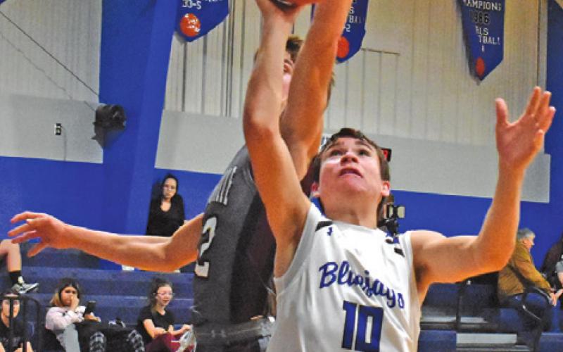 LANCE LARA OF Snook takes a shot as this Fayetteville player defends. The Bluejays battled hard but lost 59-54.