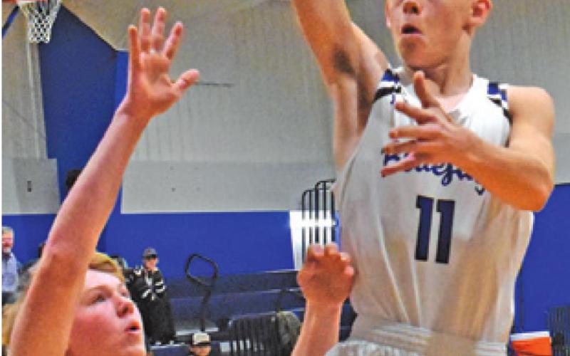 SNOOK’S JOSH GREEN leaps high for this shot against Fayetteville. The Bluejays lost 59-54. -- Tribune photo by Roy Sanders