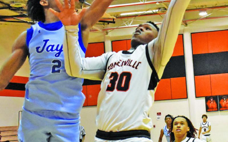 JA’KEITH DANIELS of Somerville takes a shot as Snook’s Jimmy Kearney tries to block the shot. Snook won 42-39. Tribune photo by Roy Sanders