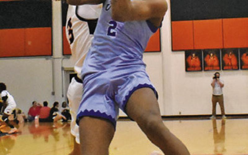JIMMY KEARNEY of Snook takes a shot as Somerville’s Jeremy Vela defends. Tribune photo by Roy Sanders