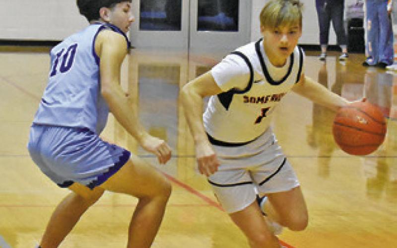 SOMERVILLE’S JADON Moses dribbles past Snook’s Braedyn Fannin. Tribune photo by Roy Sanders