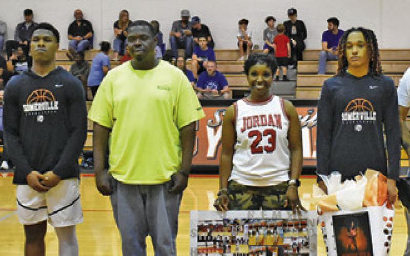 SOMERVILLE HIGH SCHOOL seniors Ja’Keith Daniels, third from the left, and Jeremy Vela Jr., third from the right, were honored on Friday, Feb. 13, before the Snook game. Also pictured, from left, are assistant coach James Klingler, Shana Daniels, Byron Mathis, Quienshia Griffin, Jeremy Vela and head coach Sheldon Bell.