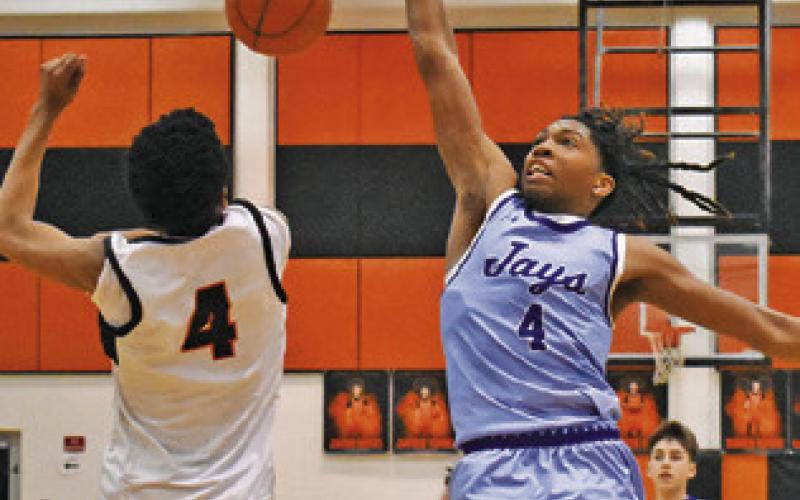 KEVIN GAINES OF Somerville and John Carr of Snook fight for this loose ball last Friday in Somerville. Snook won 42-39. Tribune photo by Roy Sanders