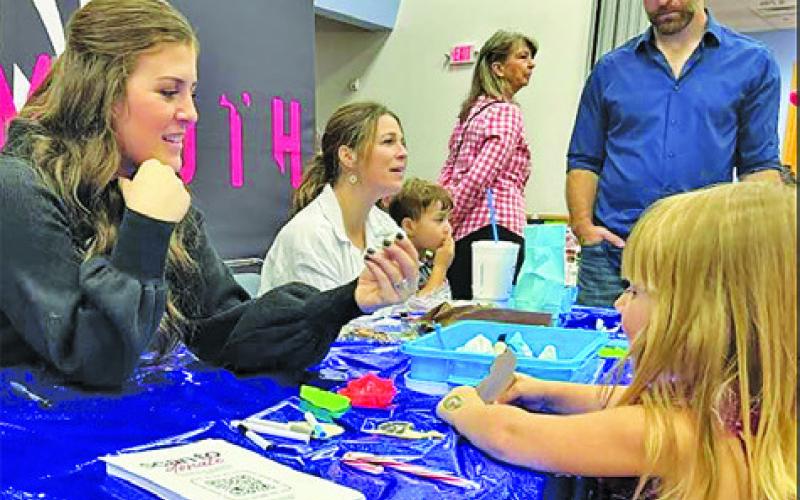 CHILDREN RECEIVED MANY giveaways at the recent Harrie P. Woodson Memorial Library’s “Miracle on Main” at the Caldwell Civic Center.