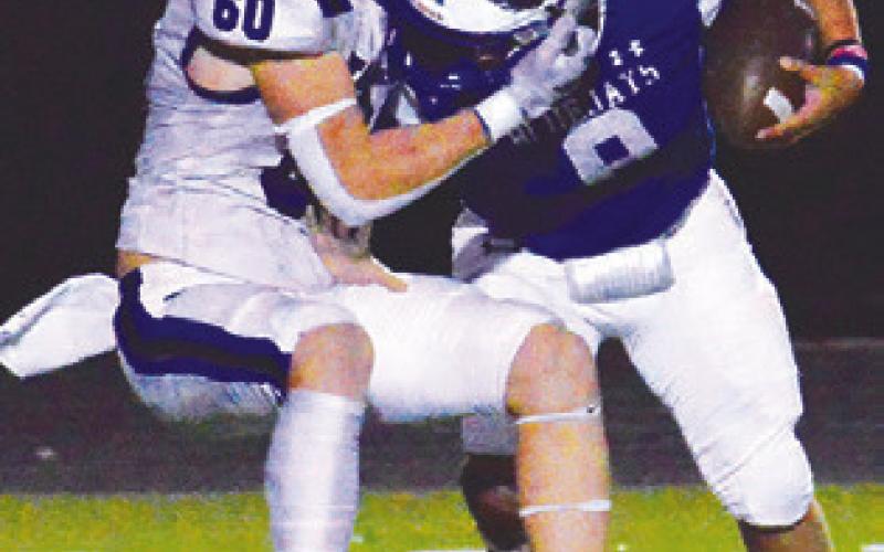 SNOOK’S JACOB Castaneda fights past this Falls City defender in last Friday’s game in Snook. Snook lost 28-0 and faces Yorktown this Friday, Oct. 27, in Yorktown.