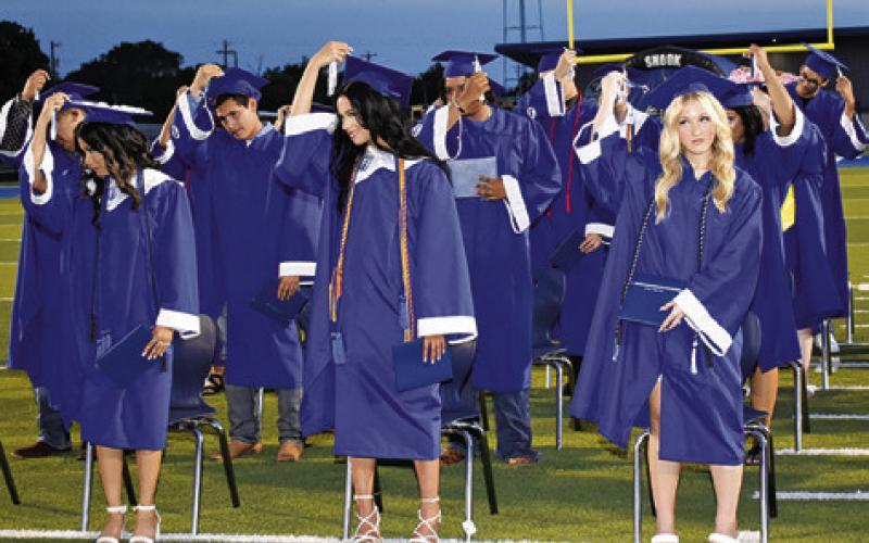 SNOOK HIGH SCHOOL graduates move their tassels on Friday at the commencement ceremony, signifying that they have graduated.