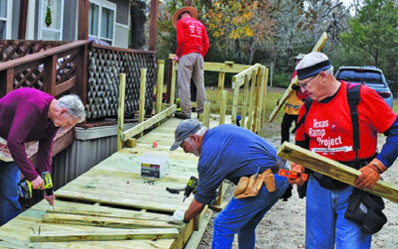 VOLUNTEERS, INCLUDING MEMBERS of the Caldwell Men’s Lions Club, build this ramp last Thursday on Park Road 57.