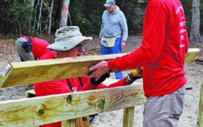 VOLUNTEERS WITH the Texas Ramp Project, with help from the Caldwell Men’s Lions Club, work on this ramp off Park Road 57.