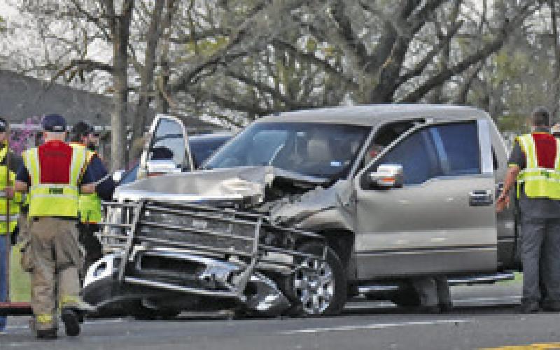 LAW OFFICERS AND Caldwell volunteer firefighters respond to this accident scene early Tuesday, March 18, on State Highway 21 West near County Road 102. No details were available at press time. Tribune photo by Roy Sanders