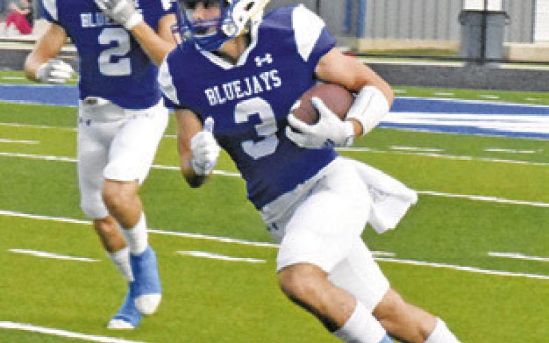 SNOOK’S JORDAN Price returns the opening kickoff for a touchdown against Brazos Christian School. -- Tribune photo by Roy Sanders