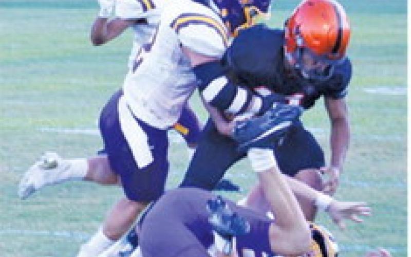 GABRIEL McDONALD fights for yards last Friday night against Weimar in Somerville. -- Tribune photo by Roy Sanders