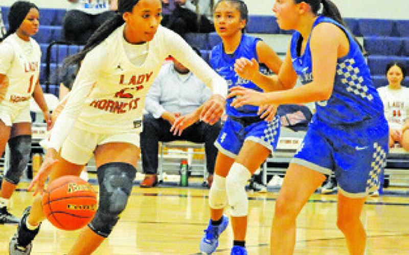 CALWELL’S TYNIAH JOHNSON presses the ball down the court during the Lady Hornets’ win over Manor New Tech last week.