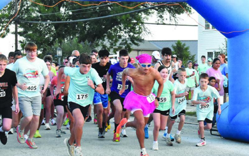 SPENCER ELLIS, CENTER, leads the pack from the starting line of Saturday’s Kolache Krunch 5K. Ellis won the race with a time of 17:25. Tribune photo by Roy Sanders