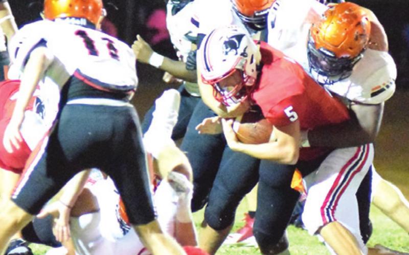 SOMERVILLE’S SEBASTIAN VEGA tackles Burton’s Chad Schubert as Somerville’s Kutter Rohrbach looks on during the Yegua-Panther football game last Friday in Burton. -- Tribune photo by Denise Squier