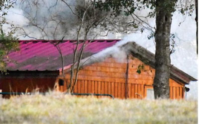 SMOKE COMES FROM the house early Wednesday, Jan. 14, as Caldwell firefighters respond again.