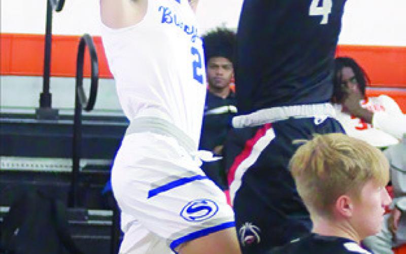BRETT WITHEM takes a shot against the Brazos Cougars. -- Photo courtesy of Darrell Vyvjala of the Schulenburg Sticker.