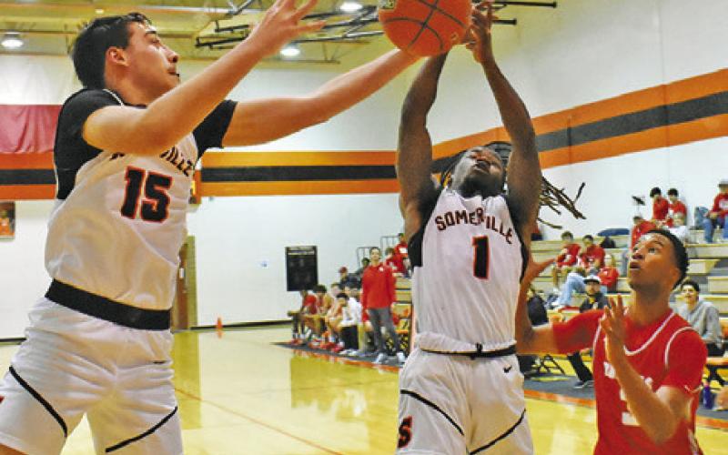 SOMERVILLE’S HERSCHEL CONWAY and Irman Sadic fight fight for the ball against Bellville. -- Tribune photo by Roy Sanders