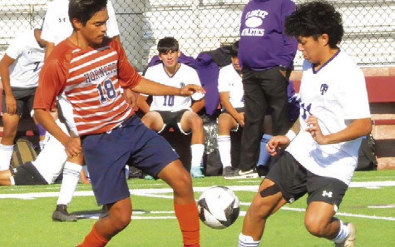 CALDWELL’S BENJAMIN JAIMES challenges a Florence player for possession of the ball during the Caldwell-Florence game last week at the Yoe Invitational Tournament. -- Tribune photo by Denise Squier