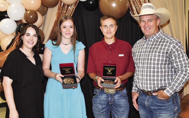BROOK FRY AND Wesley See are presented the Gold Star Awards by Megan Rogers and Steve Canon. Tribune photo by Roy Sanders