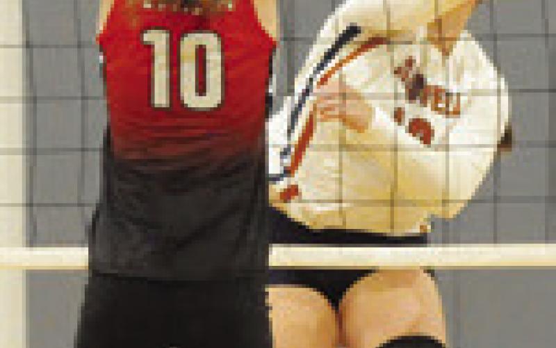 KIERSTYN MACIK punches the ball across the net during the Caldwell-BVCHEA match last Friday night in Hornet Gym. Tribune photo by Denise Squier