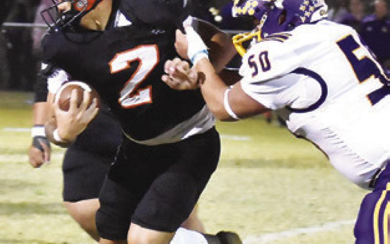QUARTERBACK IAN Teague carries the ball against Granger in the 32-15 win.