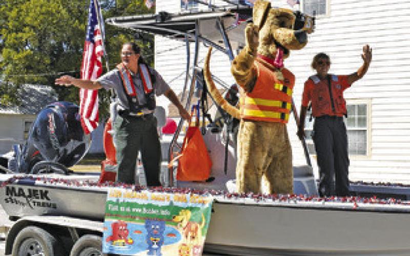THE CORPS OF Engineers staff at Lake Somerville wave to the crowd at the Somerville Homecoming Parade last Saturday.