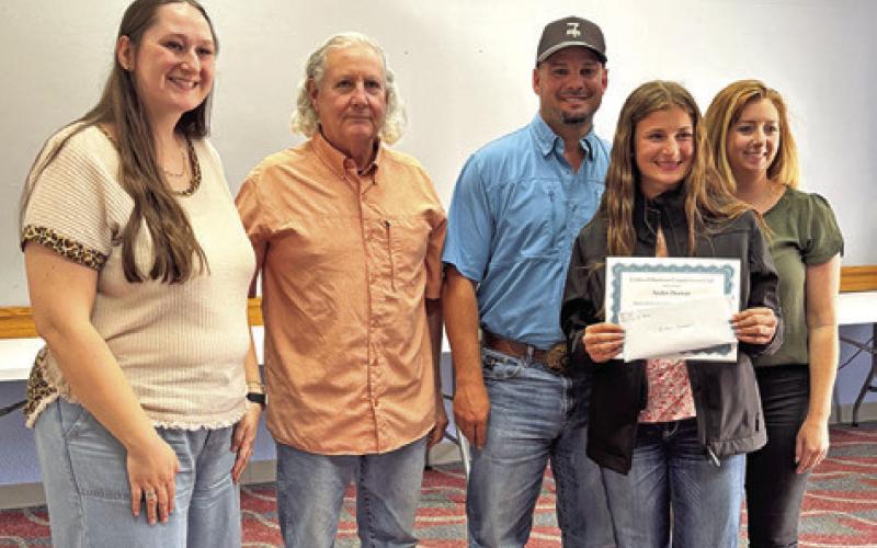 JAIDEN DOONAN, a freshman in the Animal Science path at Caldwell High School, receives a certificate and honarium from the Caldwell Burleson County Lions Club. Pictured, from left, are, teacher Abigail Wolski, Lion Bill Ballard, parents Zachary and Ashley Doonan and, in front, Jaiden Doonan. Photo courtesy of Lions club