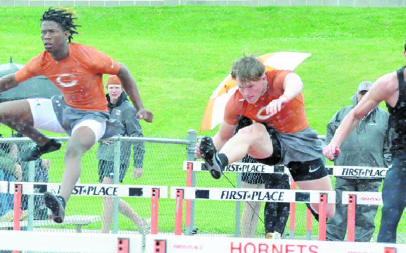 CALDWELL’S JIMMY Kearney and Corbin Stewart compete in boys hurdles at last week’s Happy Skrabanek Relays in Caldwell. See story inside. -- Tribune photo by Denise Squier