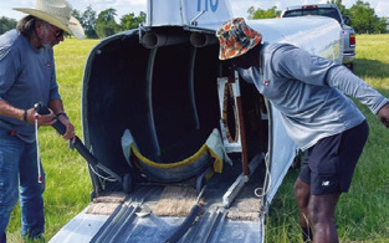 A GLIDER IS placed into this trailer and removed after an emergency landing on Aug. 5 off County Road 130. See story and additional photo inside.