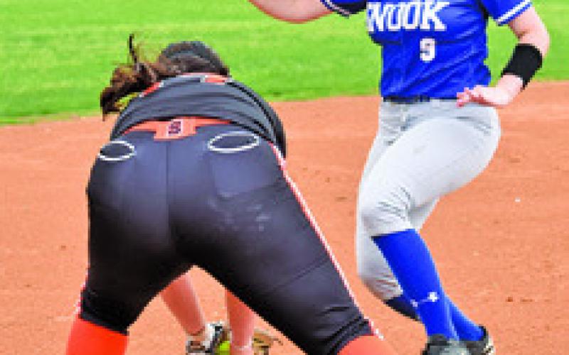 AUBREY KOVASOVIC prepares to tag Snook runner Heidi Janac during the Somerville-Snook game last Friday in Snook. Tribune photo by Roy Sanders